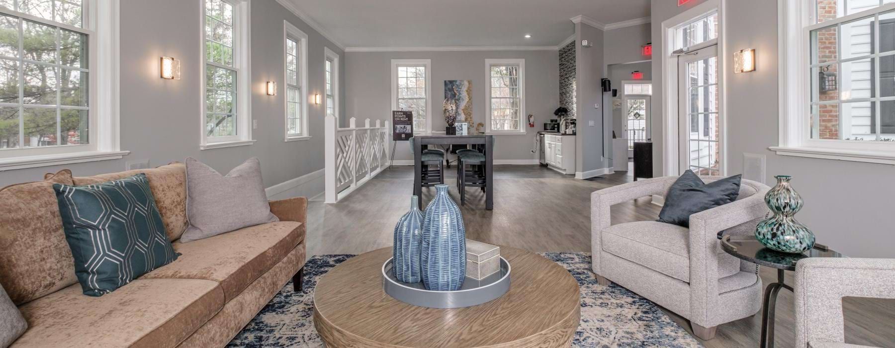 a large living room with a large chandelier and a large window