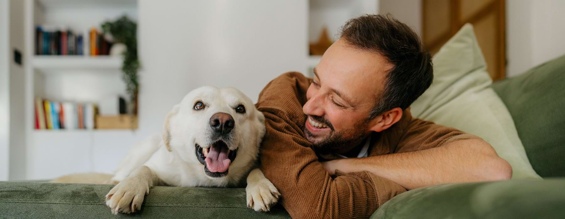 a man lying on a couch with a dog