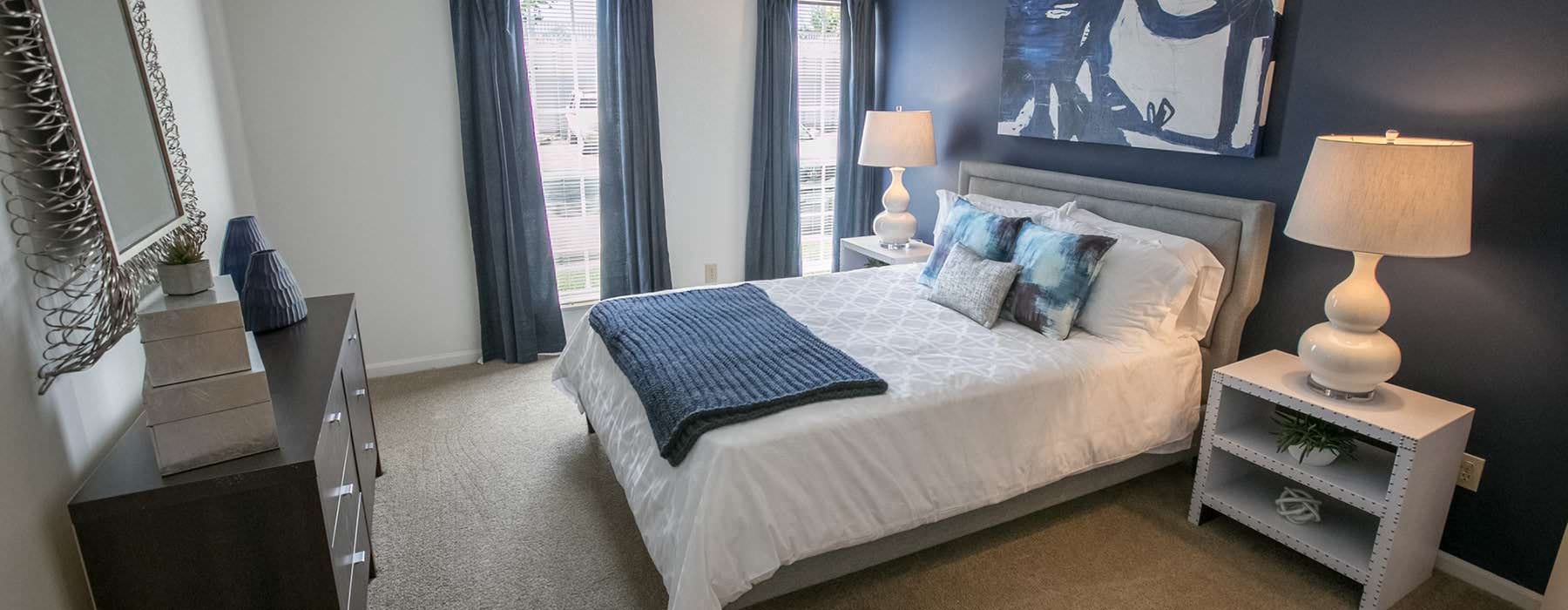 a bedroom with a bed and lamps