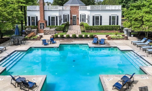 a swimming pool with chairs around it