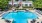 a swimming pool with chairs around it