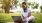 a person sitting on the grass using a laptop